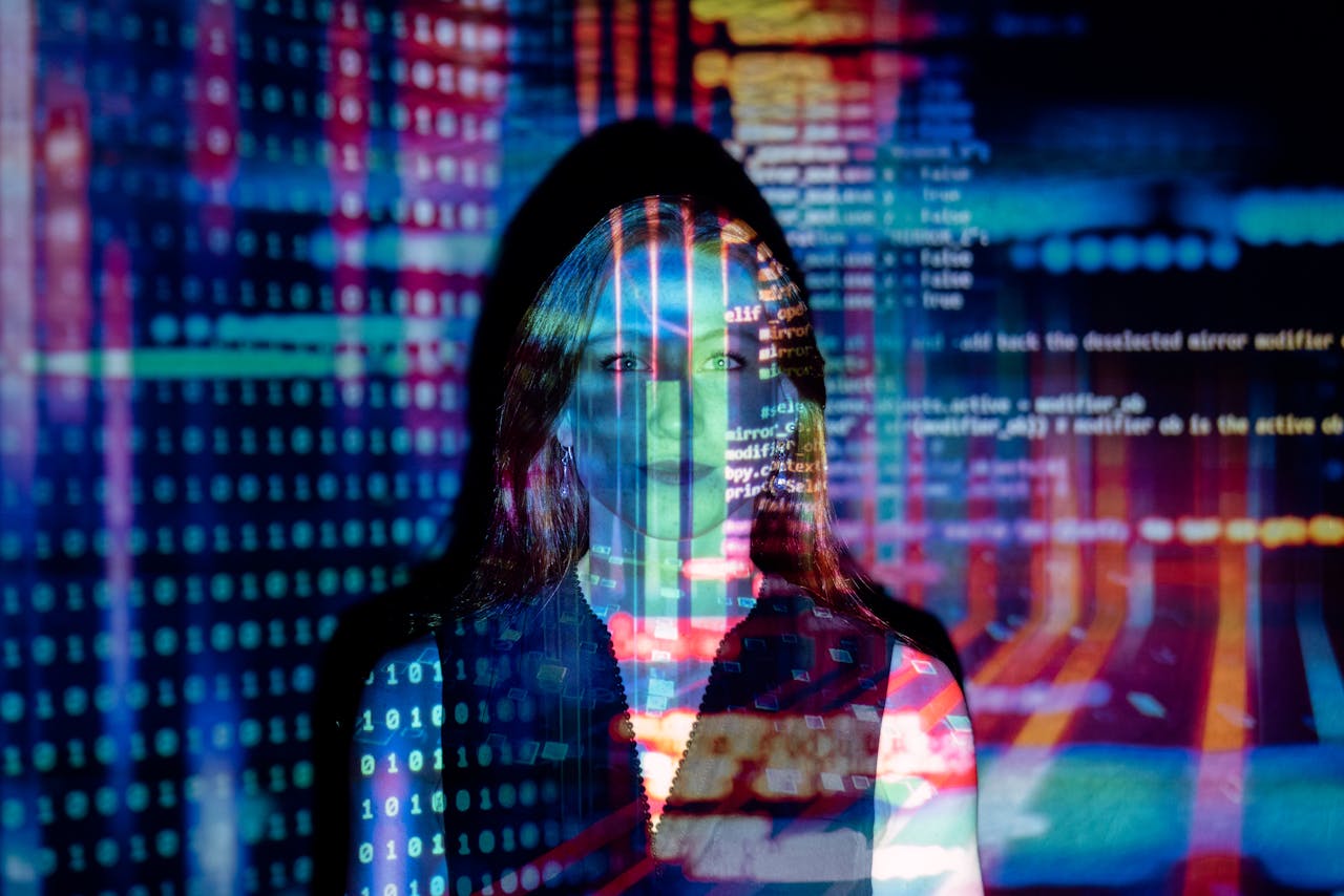 our-story A woman with digital code projections on her face, representing technology and future concepts.